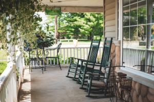 a group of chairs sitting on a porch at Hearthstone Inn & Suites in Cedarville