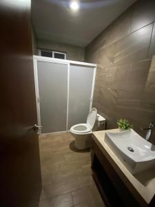 a bathroom with a toilet and a sink at AdHeDiLe & GIACAHER in Guadalupe