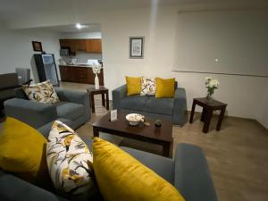 a living room with two couches and a table at AdHeDiLe & GIACAHER in Guadalupe