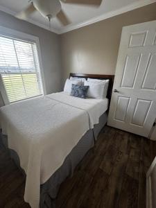 a bedroom with a bed and a white door at Red Leaf Cottages in Lake Village