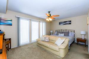 a living room with a bed and a couch at Pool Days & Water Fun Await: Lake Ozark Escape! in Lake Ozark +26 photos