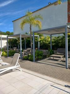 a patio with lounge chairs and a pavilion at Departamento en Condominio in Luque