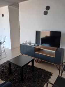 a living room with a large flat screen tv at Departamento en Condominio in Luque