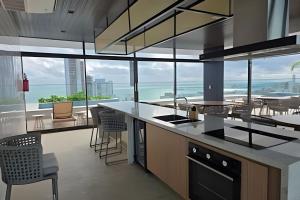 a kitchen with a view of the ocean at Beach Class Meireles by HostFacil in Fortaleza