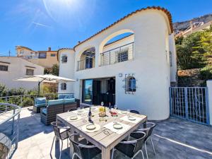 a patio with a table and chairs and a building at Bona Vista in Calpe
