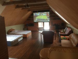 a living room with a large tv and a couch at Kalvi tee Puhkemaja in Viru-Nigula
