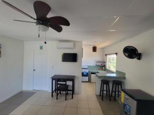 a kitchen with a ceiling fan and a table at Ocean View in Big Corn Island +18 photos