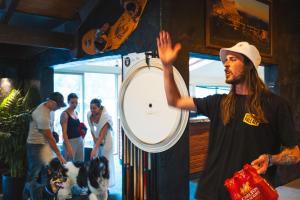 a man standing in front of a mirror with a dog at Harrietville Hotel Motel in Harrietville