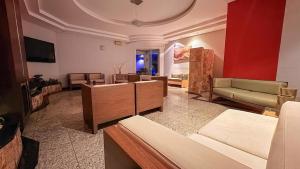 a large living room with couches and a couch at Style Hotel ( Adults Only) in São Paulo