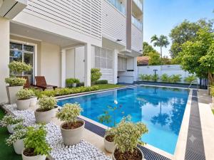 a swimming pool in the backyard of a house with potted plants at Apna Colombo in Nawala