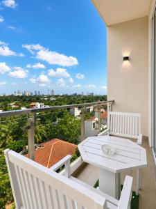 a balcony with a white table and chairs and a view at Apna Colombo in Nawala