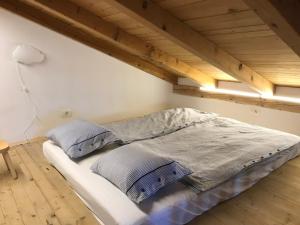 a bed with two pillows on it in a room at Lucica 1 Beachfront House in Lastovo