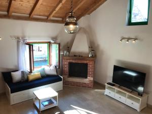 a living room with a couch and a tv at Lucica 1 Beachfront House in Lastovo