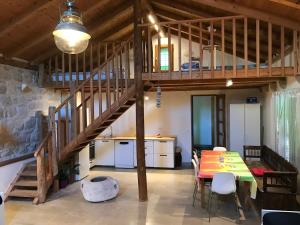 a dining room with a table and a loft at Lucica 1 Beachfront House in Lastovo