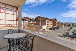 a balcony with a table and a view of a street at Zermatt Mountain Suite and 1BDR in Midway