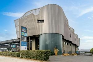 a large building with a sign in front of it at Comfort Aparthotel Bordeaux Begles Arena in Bègles