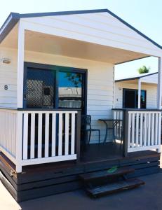 a screened in porch with a table on a deck at The Hotel Pioneer Brandon in Brandon