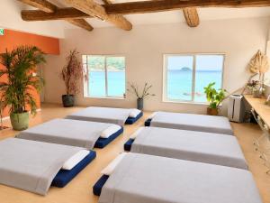 a room with four beds in a room with the ocean at SEABASE villa at shimane in Matsue