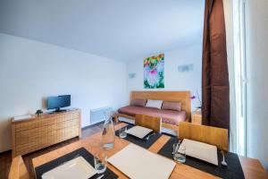 a living room with a couch and a table at Comfort Aparthotel Mutzig Portes d'Alsace in Mutzig