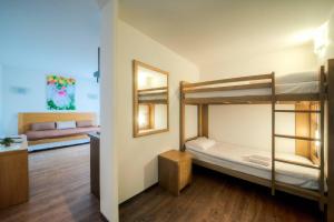 a room with two bunk beds and a mirror at Comfort Aparthotel Mutzig Portes d'Alsace in Mutzig +72 photos