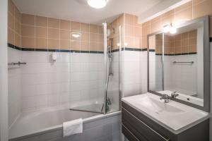 a bathroom with a tub and a sink and a shower at Comfort Aparthotel Lourdes Lorda in Lourdes +74 photos