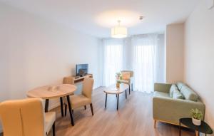 a living room with a couch and a table at Quality Aparthotel Moissy-Cramayel in Moissy-Cramayel