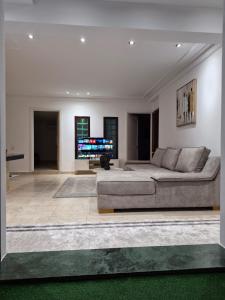 a living room with a couch and a flat screen tv at Rabat hassan in Rabat