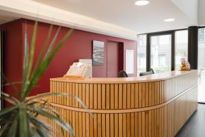 an office with a reception desk with a phone at Quality Aparthotel Saint-Malo in Saint Malo