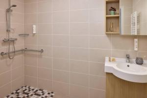 a bathroom with a sink and a shower at Quality Aparthotel Pau Porte Des Pyrénées in Pau +39 photos