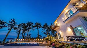 a house with lights on the side of it at Yeosu Sky Pension in Yeosu