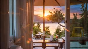 a table on a balcony with a view of the ocean at Yeosu Sky Pension in Yeosu +3 photos