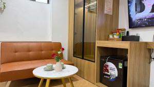 a room with a table and a chair and a coffee table at Sky Hotel in Ninh Binh