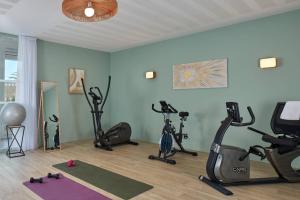 a gym with several exercise bikes in a room at Quality Aparthotel Quiberon in Quiberon