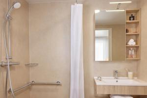 a bathroom with a shower and a sink at Quality Aparthotel Cherbourg in Cherbourg en Cotentin +35 photos