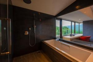 a bathroom with a large tub and a sink at The ACONCAGUA RESORTS in Minami Aso +62 photos