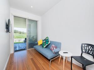 a living room with a couch and a table at 41 Ocean in Anna Bay