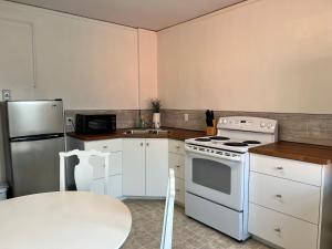 a kitchen with a white stove and a refrigerator at Grand Union Hotel in Coleman