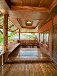 an empty porch of a house with wooden flooring at Thai Style House - Yao Noi in Ko Yao Noi