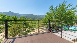 a balcony with a view of the mountains at Gapyeong ebenzer Pension in Gapyeong