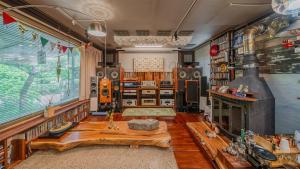 a living room with a table and a fireplace at Gapyeong ebenzer Pension in Gapyeong