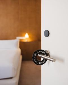 a door knob on a white door with a bed at Círculo Condal in Barcelona