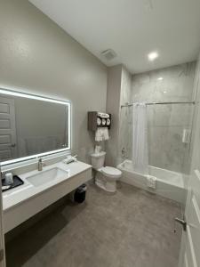 a bathroom with a sink and a toilet and a shower at Clarion Pointe Port Lavaca in Port Lavaca +67 photos