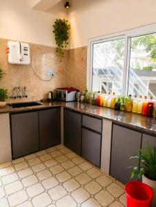 a kitchen with black cabinets and a window at The two bedroom house in Madikeri