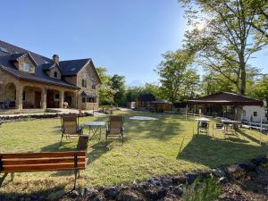 a yard with a table and chairs and a house at Resort Door in Yamanakako