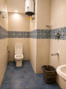 a bathroom with a toilet and a sink at The two bedroom house in Madikeri +25 photos