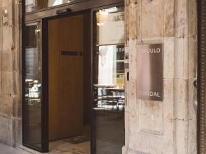 a door to a building with the sign for cornell at Círculo Condal in Barcelona +51 photos