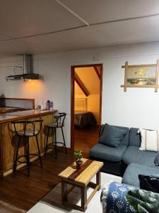 a living room with a blue couch and a table at Departamento la espiga in Chaitén