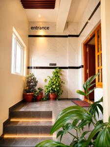 a hallway with potted plants in a building at The two bedroom house in Madikeri