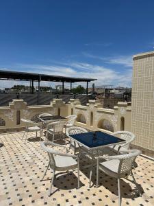 a patio with tables and chairs on a roof at SILVER Inn in Bukhara