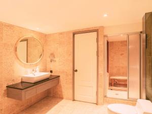 a bathroom with a sink and a mirror at Rhyme&Time Hotel in Kaohsiung